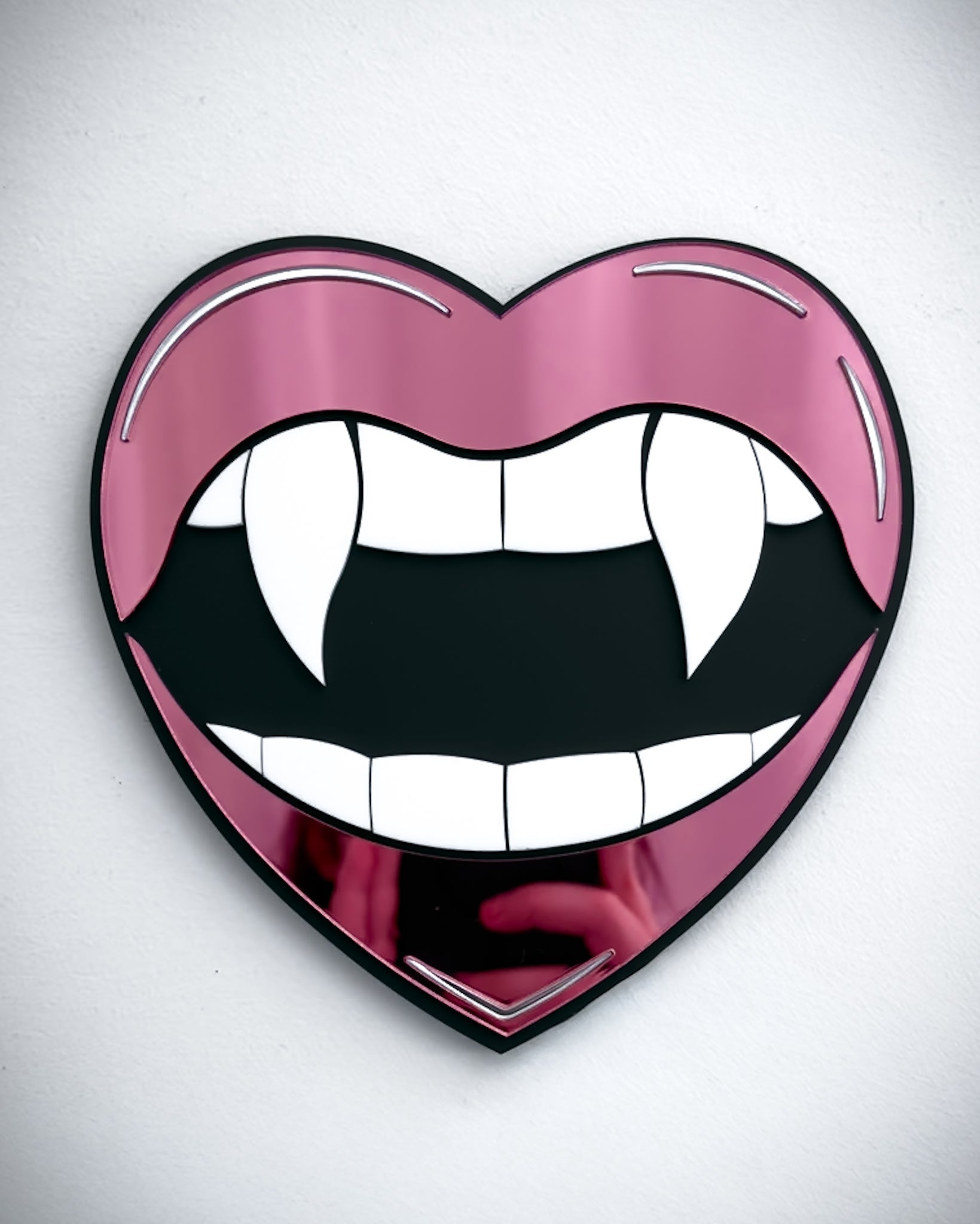 Gothic vampire lips mirror wall art in pink acrylic with fangs and black centre