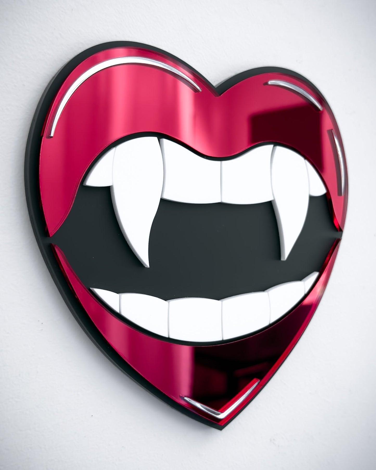 Side view of Gothic vampire lips mirror wall art in red acrylic with fangs and black centre